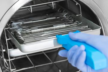 Dentist assistant's hands get out sterilizing medical instruments from autoclave- Stock Photo or Stock Video of rcfotostock | RC Photo Stock