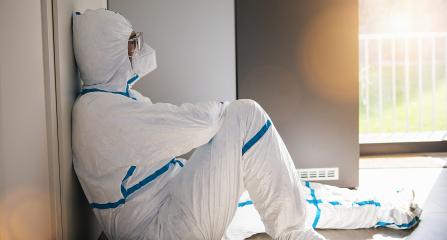 Doctor lies in protective clothing with stress and burnout in clinic leaning against window at Covid-19 coronavirus epidemic : Stock Photo or Stock Video Download rcfotostock photos, images and assets rcfotostock | RC-Photo-Stock.: