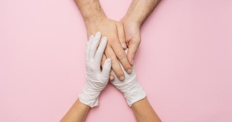 Doctor's hands holding woman hands in gloves. Medical banner with copy space on pink background. Care concept image- Stock Photo or Stock Video of rcfotostock | RC Photo Stock