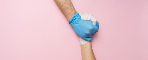 Doctor's hands or helpers hands in gloves holding together hands. Fight together in the Corona pandemic. Medical banner with copy space on pink background. - Stock Photo or Stock Video of rcfotostock | RC Photo Stock