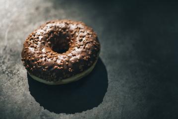 donut with chocolate glazed and sprinkles on a dark table- Stock Photo or Stock Video of rcfotostock | RC-Photo-Stock