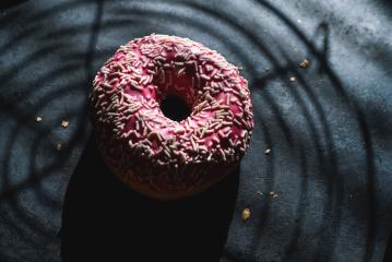 donut with pink glazed and sprinkles and Baking grid shadow- Stock Photo or Stock Video of rcfotostock | RC-Photo-Stock