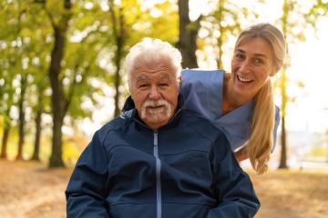 Elderly man in a wheelchair sharing a joyful moment with a nurse in a sunlit park, both smiling warmly : Stock Photo or Stock Video Download rcfotostock photos, images and assets rcfotostock | RC Photo Stock.: