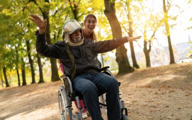 Elderly man in astronaut helmet joyfully extends arms as if flying, with a nurse smiling beside him in an autumn park. Dementia retirement home concept image- Stock Photo or Stock Video of rcfotostock | RC Photo Stock