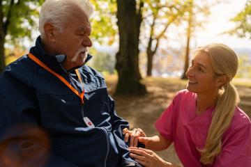 Elderly man with caregiver in a park, both interacting joyfully, man wears an SOS button on his jacket : Stock Photo or Stock Video Download rcfotostock photos, images and assets rcfotostock | RC Photo Stock.: