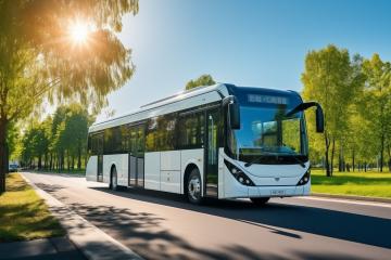 Electric bus driving on road lined with green trees
 : Stock Photo or Stock Video Download rcfotostock photos, images and assets rcfotostock | RC Photo Stock.: