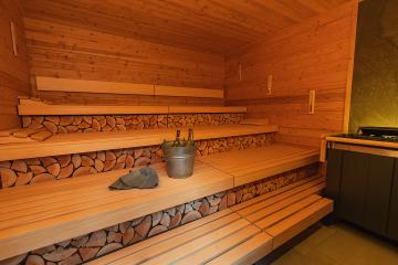 Empty finnish sauna room with wooden benches and walls, sauna stones heater, bucket, and ladle and  felt hats. Wellness Spa Hotel Conept image.- Stock Photo or Stock Video of rcfotostock | RC Photo Stock