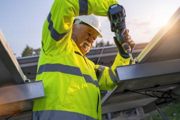 Engineer using a cordless drill to install solar panels at dawn. Alternative energy ecological concept image. : Stock Photo or Stock Video Download rcfotostock photos, images and assets rcfotostock | RC Photo Stock.: