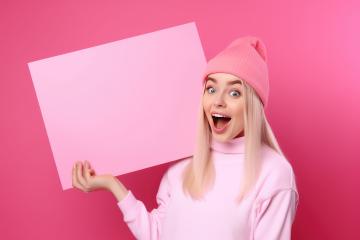 Excited blonde woman in pink holding a large blank pink sign- Stock Photo or Stock Video of rcfotostock | RC Photo Stock