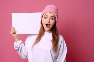 Excited young woman in pink beanie holding blank white sign : Stock Photo or Stock Video Download rcfotostock photos, images and assets rcfotostock | RC Photo Stock.: