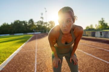 Exhausted woman resting on a running track after workout : Stock Photo or Stock Video Download rcfotostock photos, images and assets rcfotostock | RC Photo Stock.: