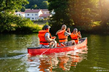 Family in life jackets canoeing on a serene river with vibrant greenery and a sunlit background at summer in germany. Family on kayak ride. Wild nature and water fun on summer Vacation.- Stock Photo or Stock Video of rcfotostock | RC Photo Stock