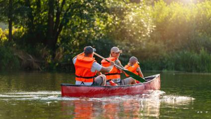 Family in life jackets enjoying a canoe ride on a river, surrounded by lush greenery and sparkling water. Family on kayak ride. Wild nature and water fun on summer Vacation.- Stock Photo or Stock Video of rcfotostock | RC Photo Stock