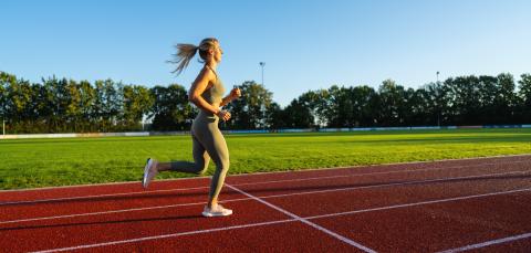 Female athlete running on a sunny track field- Stock Photo or Stock Video of rcfotostock | RC Photo Stock
