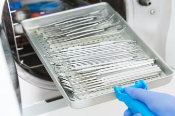 Female Dentist Places Medical Autoclave For Sterilising Surgical And Other Instruments- Stock Photo or Stock Video of rcfotostock | RC-Photo-Stock