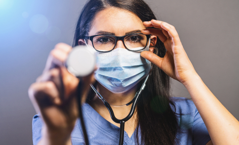 female doctor in a medical mask holds a stethoscope. Concept med- Stock Photo or Stock Video of rcfotostock | RC Photo Stock
