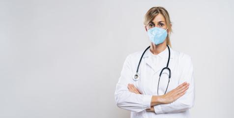 Female Doctor wearing N95 FFP2 an anti virus protection mask to prevent others from corona COVID-19 and SARS cov 2 infection, with copy space for individual text- Stock Photo or Stock Video of rcfotostock | RC Photo Stock