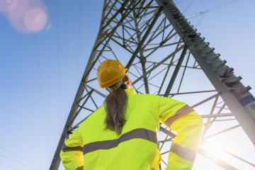 female electrical engineer standing and watching at the electric power station to view the planning work by producing electricity at high voltage electricity poles.- Stock Photo or Stock Video of rcfotostock | RC Photo Stock