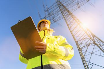 female electrical engineer standing with clipboard and watching at the electric power station to view the planning work by producing electricity at high voltage electricity poles. : Stock Photo or Stock Video Download rcfotostock photos, images and assets rcfotostock | RC Photo Stock.: