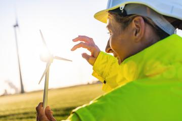 female engineer holding wind turbine model against sun. New Energy concept image : Stock Photo or Stock Video Download rcfotostock photos, images and assets rcfotostock | RC Photo Stock.: