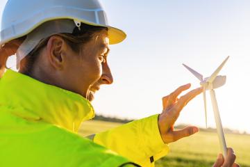 female engineer holding wind turbine model and play with propellers at sunset- Stock Photo or Stock Video of rcfotostock | RC Photo Stock