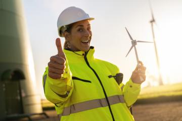 female engineer holding wind turbine model and thumbs up at a windfarm. New Energy concept image- Stock Photo or Stock Video of rcfotostock | RC Photo Stock