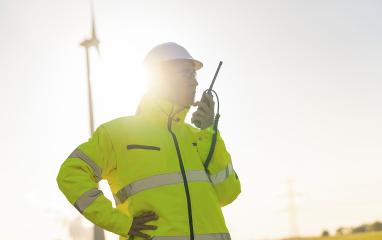 female engineer with safety jacket using walkie talkie to checking wind turbine system at new enegry farm- Stock Photo or Stock Video of rcfotostock | RC Photo Stock