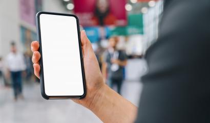 Female hand of a business woman holding black cellphone with white screen at a trade fair, copyspace for your individual text.- Stock Photo or Stock Video of rcfotostock | RC-Photo-Stock