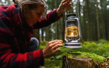 Female Hiker ignite a kerosene lamp or oil lamp in the forest. authentic close-up shot. Travel concept image- Stock Photo or Stock Video of rcfotostock | RC Photo Stock