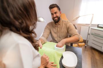 Female manicurist giving manicure to  smiling man in a beauty salon. body care spa treatment concept image : Stock Photo or Stock Video Download rcfotostock photos, images and assets rcfotostock | RC Photo Stock.: