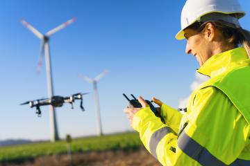 Female Operator inspecting Wind turbine with drone. Drone inspec : Stock Photo or Stock Video Download rcfotostock photos, images and assets rcfotostock | RC Photo Stock.: