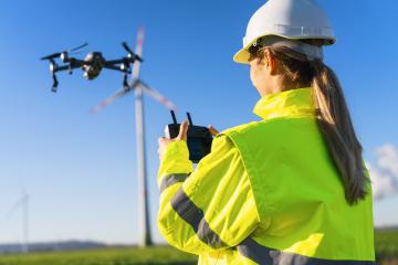 Female Operator inspecting Wind turbine with drone. Drone inspec- Stock Photo or Stock Video of rcfotostock | RC Photo Stock