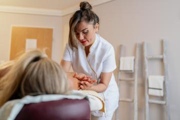 Focused massage therapist working on female client's back at a spa. beauty salon Wellness Hotel Concept image : Stock Photo or Stock Video Download rcfotostock photos, images and assets rcfotostock | RC Photo Stock.: