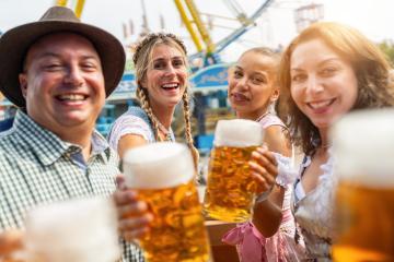 Four friends cheerfully toasting with large beer mugs at a vibrant Oktoberfest or dult in germany- Stock Photo or Stock Video of rcfotostock | RC Photo Stock