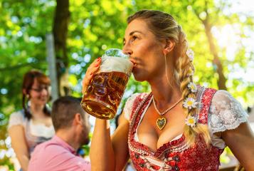 Friends girls and man, having fun in beer garden holding beer mug and traditional Bavaria pretzels in front of a wooden beer barrel at Oktoberfest, Munich, Germany : Stock Photo or Stock Video Download rcfotostock photos, images and assets rcfotostock | RC Photo Stock.: