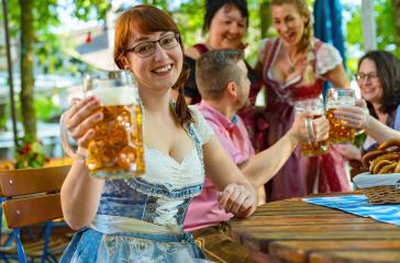 Friends in Bavarian beer garden  or oktoberfest drinking in summer- Stock Photo or Stock Video of rcfotostock | RC Photo Stock