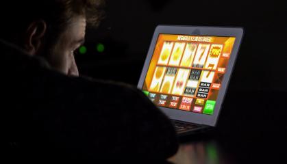 Gambling addicted man with glasses in front of online casino slot machine on laptop computer at night - loosing his money. Dramatic low light grain shot.- Stock Photo or Stock Video of rcfotostock | RC-Photo-Stock