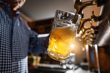 German bartender pouring beer in mug at Biergarten or Oktoberfest, Munich, Germany- Stock Photo or Stock Video of rcfotostock | RC Photo Stock