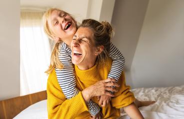 girl and her mother enjoy playing in the bedroom. Good time at home. Family playing on the bed in the bedroom.- Stock Photo or Stock Video of rcfotostock | RC Photo Stock