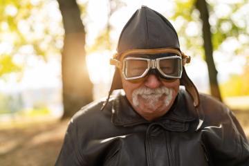 grandfather in aviator gear smiling, with autumn trees and sunlight in the background. Dementia retirement home concept image- Stock Photo or Stock Video of rcfotostock | RC Photo Stock