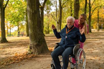 grandfather in wheelchair with nurse in park, autumn setting, wearing a SOS button for safety : Stock Photo or Stock Video Download rcfotostock photos, images and assets rcfotostock | RC Photo Stock.: