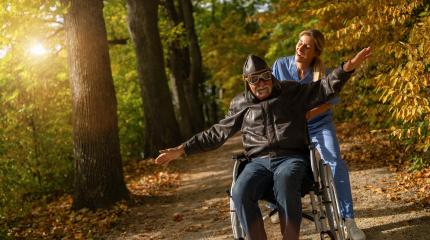 grandpa in an aviator outfit and goggles having fun in a wheelchair, with a nurse in a park, both happy. nursery home concept image  : Stock Photo or Stock Video Download rcfotostock photos, images and assets rcfotostock | RC Photo Stock.: