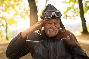 grandpa in aviator gear saluting with a playful smile, sitting in a wheelchair in a sunlit autumn park. Dementia retirement home concept image : Stock Photo or Stock Video Download rcfotostock photos, images and assets rcfotostock | RC Photo Stock.: