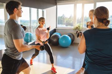Group fitness class with dumbbells, bright gym, exercise balls, large windows : Stock Photo or Stock Video Download rcfotostock photos, images and assets rcfotostock | RC Photo Stock.: