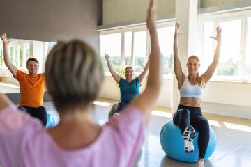 Group of diverse people in a receding line doing pilates in a gym balancing on a gym balls with hands up toning their muscles. Healthy sports lifestyle, Fitness, Healthy concept. : Stock Photo or Stock Video Download rcfotostock photos, images and assets rcfotostock | RC Photo Stock.: