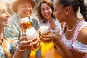 group of friends in traditional Bavarian attire joyfully toasting with beer mugs at Oktoberfest or Dult in germany : Stock Photo or Stock Video Download rcfotostock photos, images and assets rcfotostock | RC Photo Stock.: