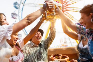 Group of friends toasting with beer mugs at an outdoor festival, joyful expressions, ferris wheel in background at oktoberfest or dult in germany- Stock Photo or Stock Video of rcfotostock | RC Photo Stock