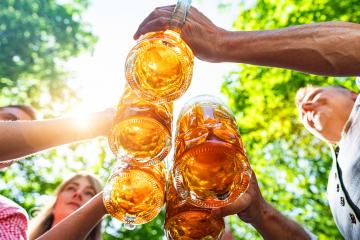 Group of happy Bavarian friends drinking and toasting beer at Oktoberfest, folk or beer festival in germany - Stock Photo or Stock Video of rcfotostock | RC Photo Stock