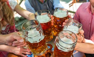 Group of happy friends drinking and toasting beer at Oktoberfest in bavaria- Stock Photo or Stock Video of rcfotostock | RC Photo Stock