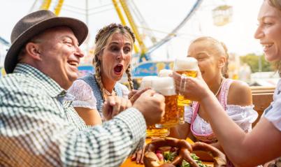 group of men and women in traditional Tracht drinking beer and having a party with beer mugs in a beer tent at Dult or Oktoberfest - Stock Photo or Stock Video of rcfotostock | RC Photo Stock